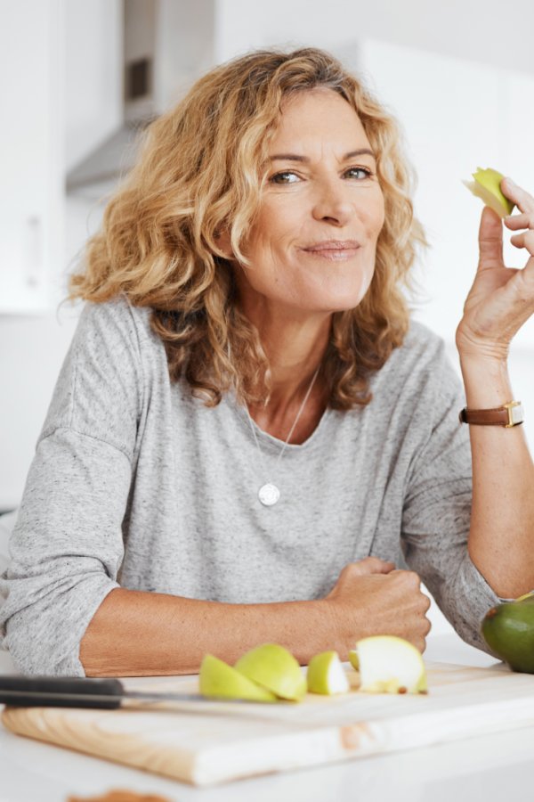 woman surrounded by fruit for a healthy meal, healthy lifestyle