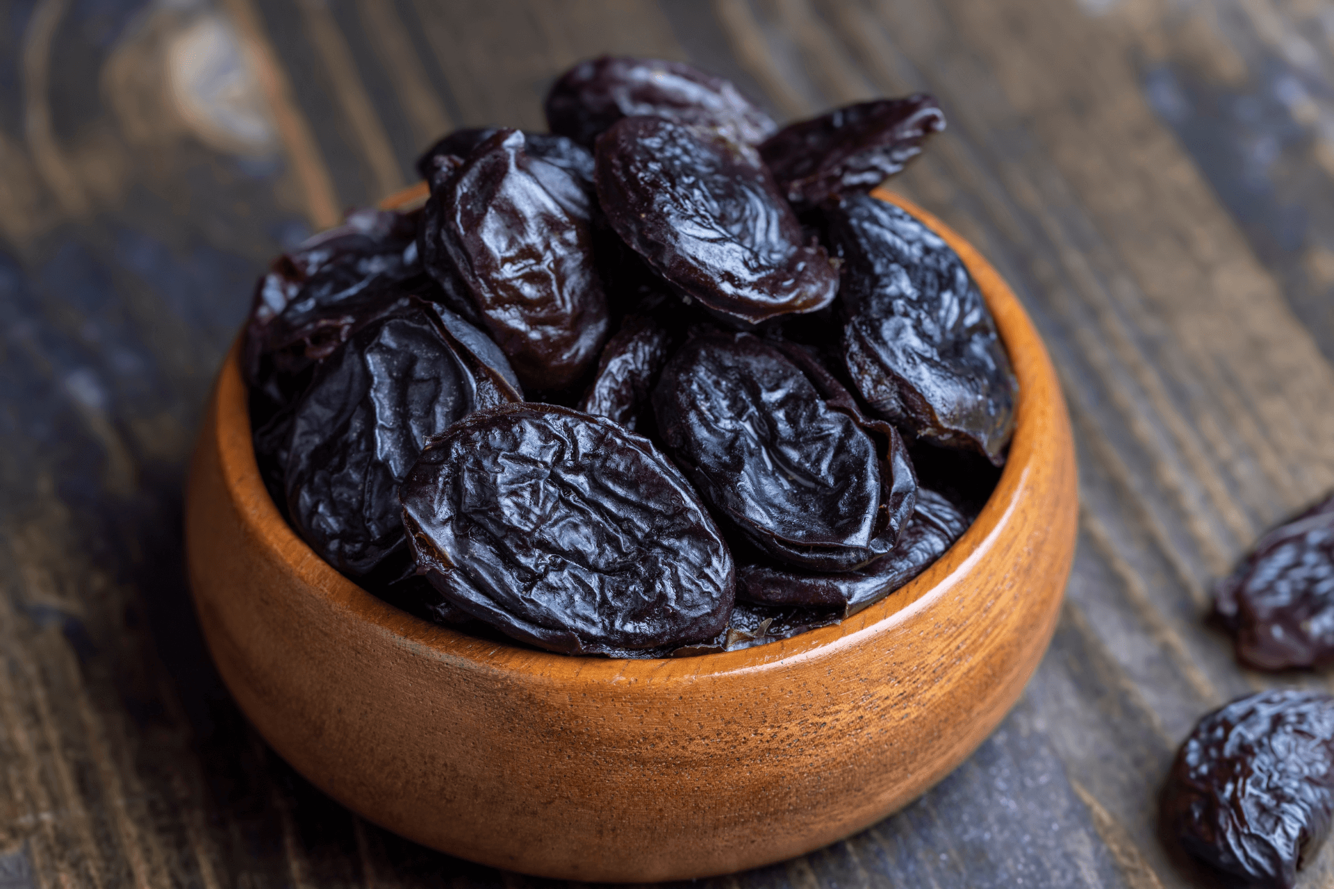 A cup with prunes. Prunes are one of the most well-known natural remedies for combating constipation.